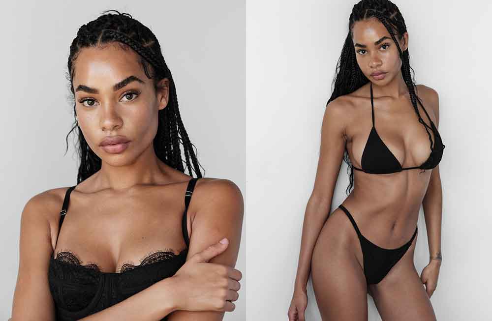 A woman in black bikini posing for the camera.
