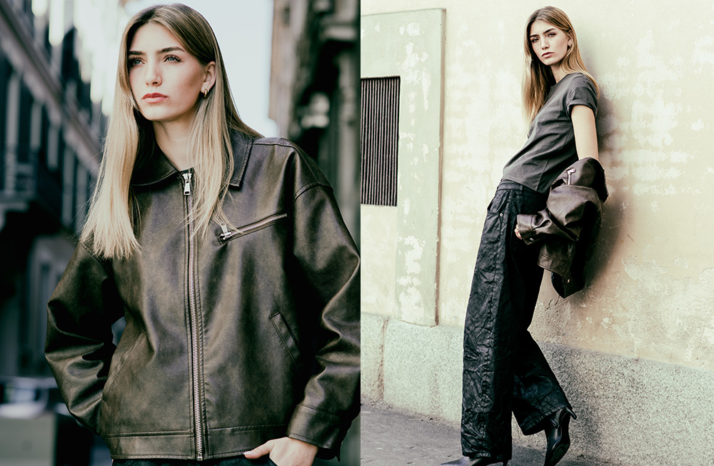 Fashionable woman in a stylish dark outfit posing outdoors.