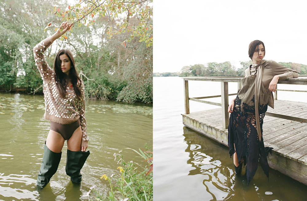 Two women posing near water in fashionable outfits with boots.
