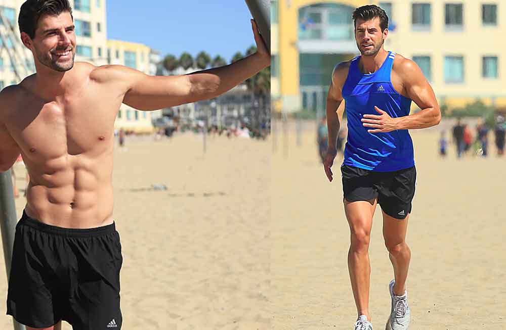 Two men running on the beach with a racquet.