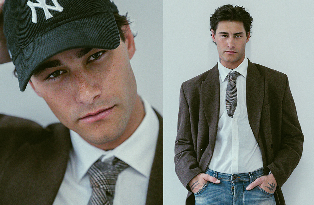 Stylish young man in casual-chic outfit with a blazer and cap.