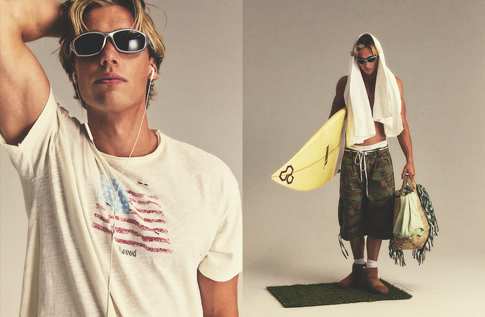 Stylish man in sunglasses with American flag t-shirt and surfboard.